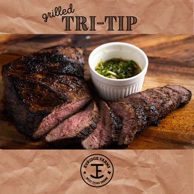 grilled tri-tip with chimichurri sauce on wood cutting board